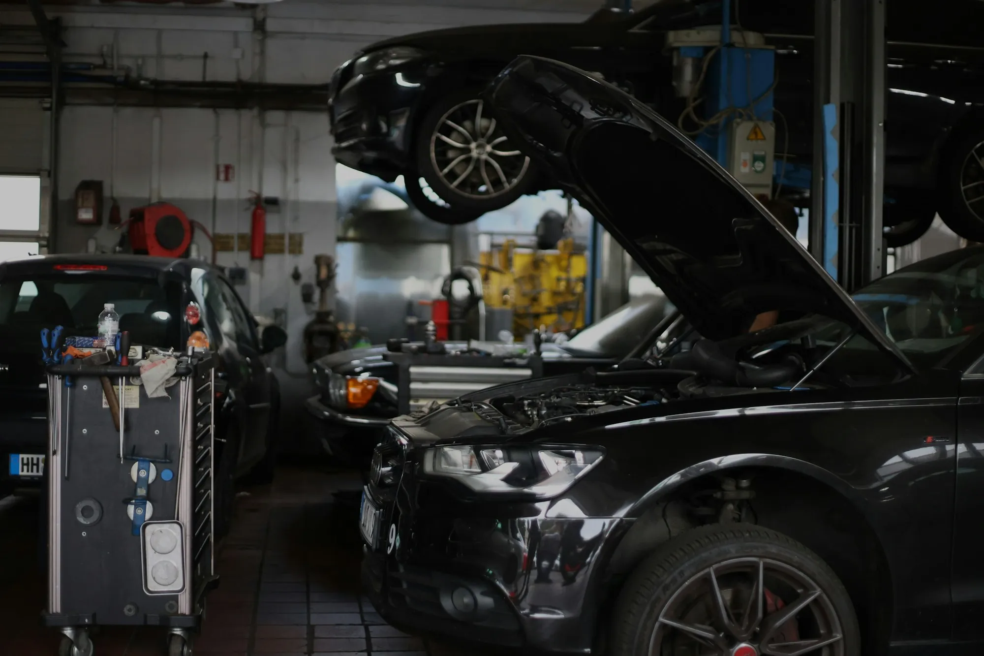 Repair bay with a car on a lift and diagnostic equipment