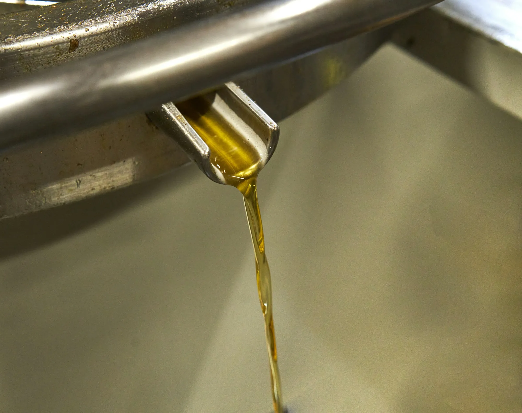 Golden motor oil being poured during a service